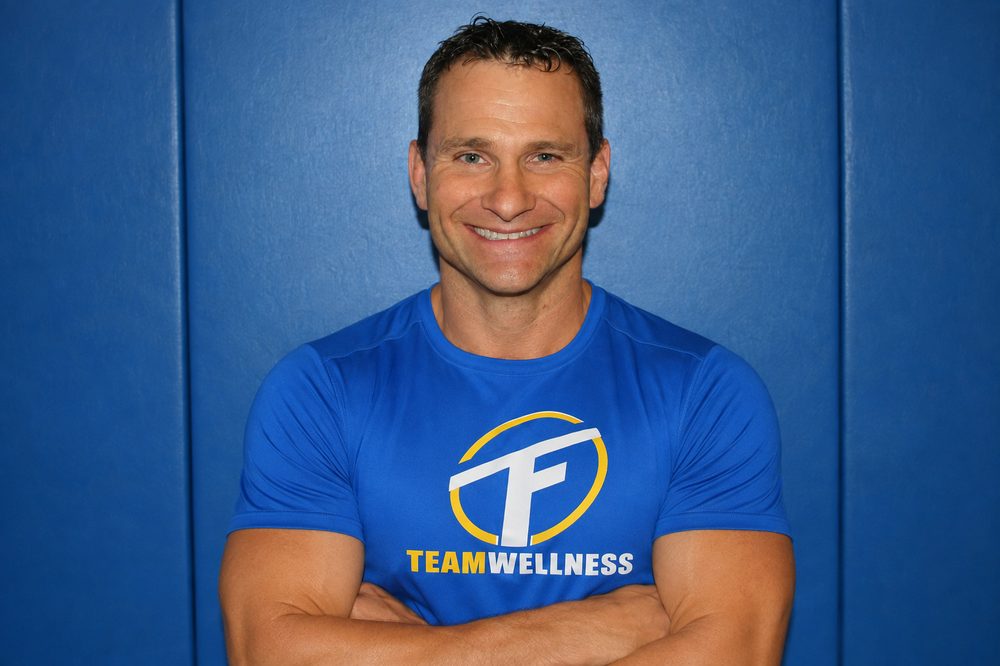 Team Wellness staff member in clinic brand shirt
